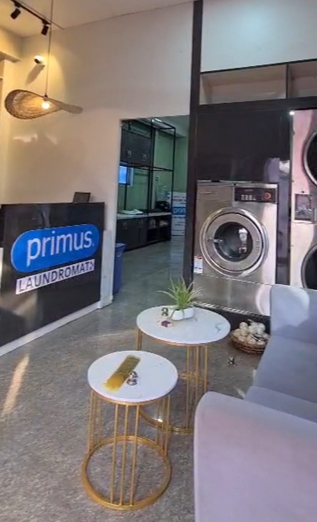 Front view of Primus Laundromat store in Imphal with signage and customers.